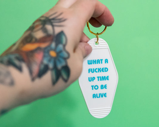 What a Fucked Up Time to Be Alive Motel Style Keychain in White